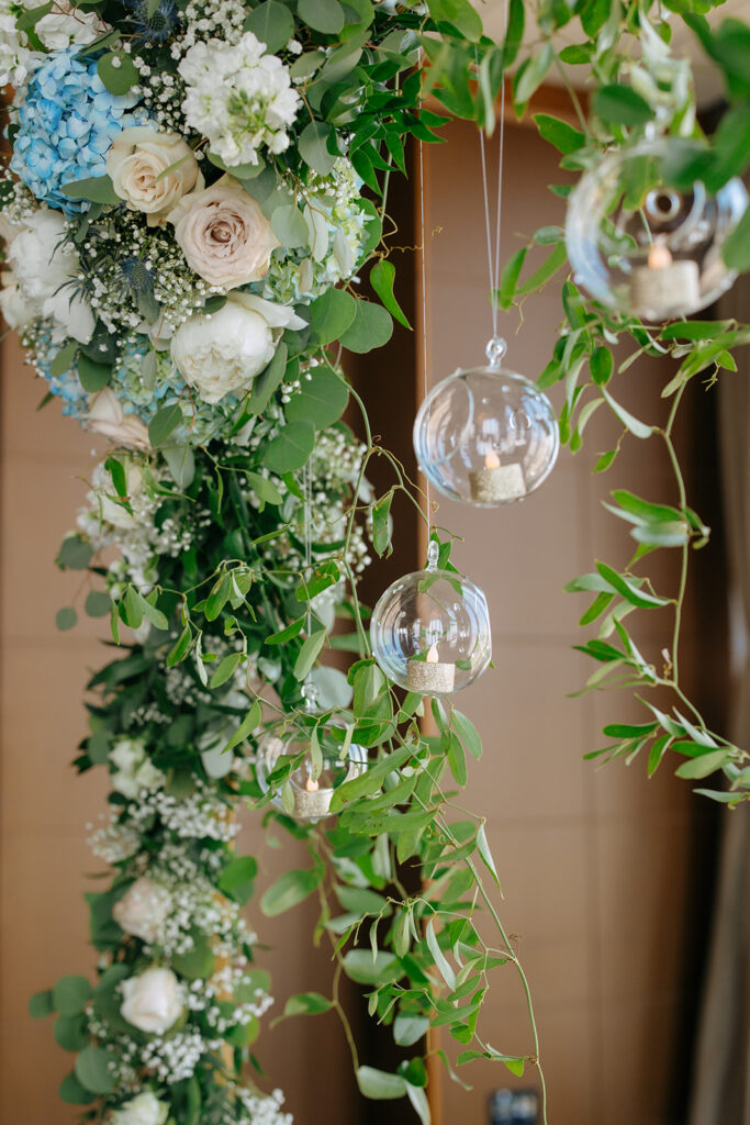 wedding arch details with glass globes and tea lights 
