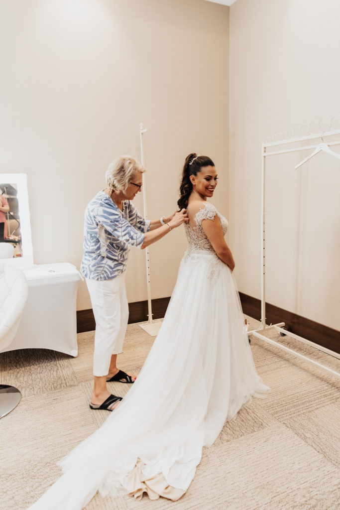 Mother of the bride getting ready wedding dress