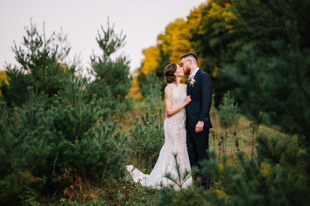 couple wedding portrait kissing woods