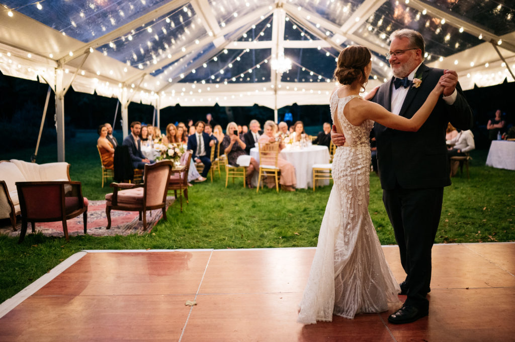 father daughter dance under clear top tent