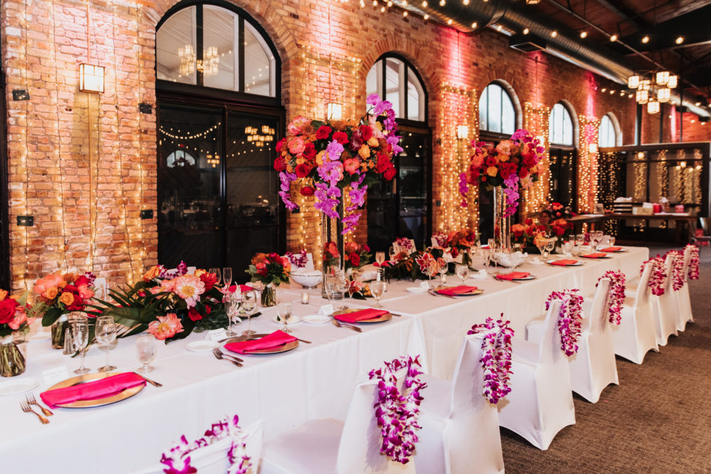 tropical wedding themed head table hot pink