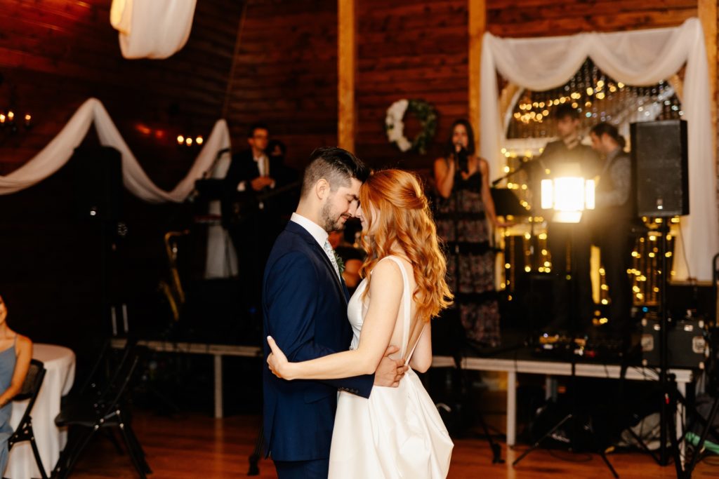 bride and groom first dance at barn wedding venue
