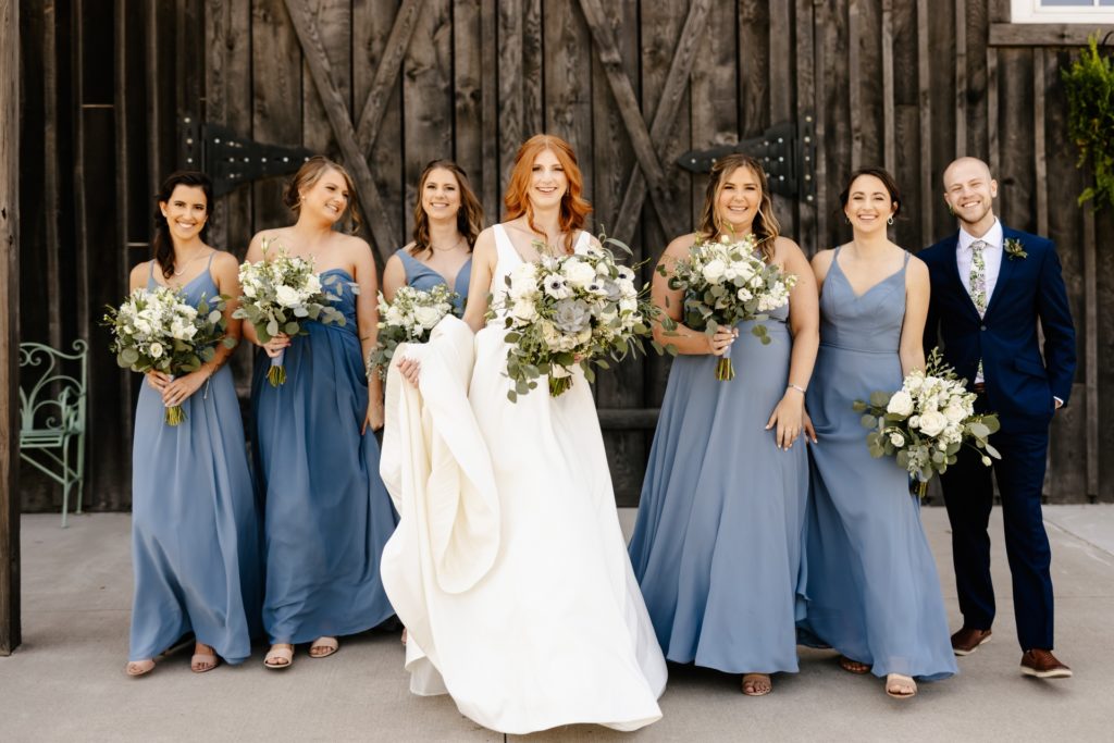 bridesmaids walking group photo dusty blue dresses