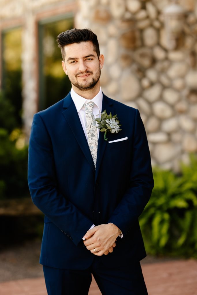 groom portrait blue suit succulent boutoniere