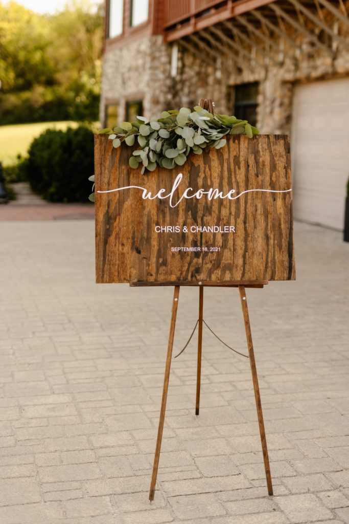 wooden welcome sign with eucalyptus