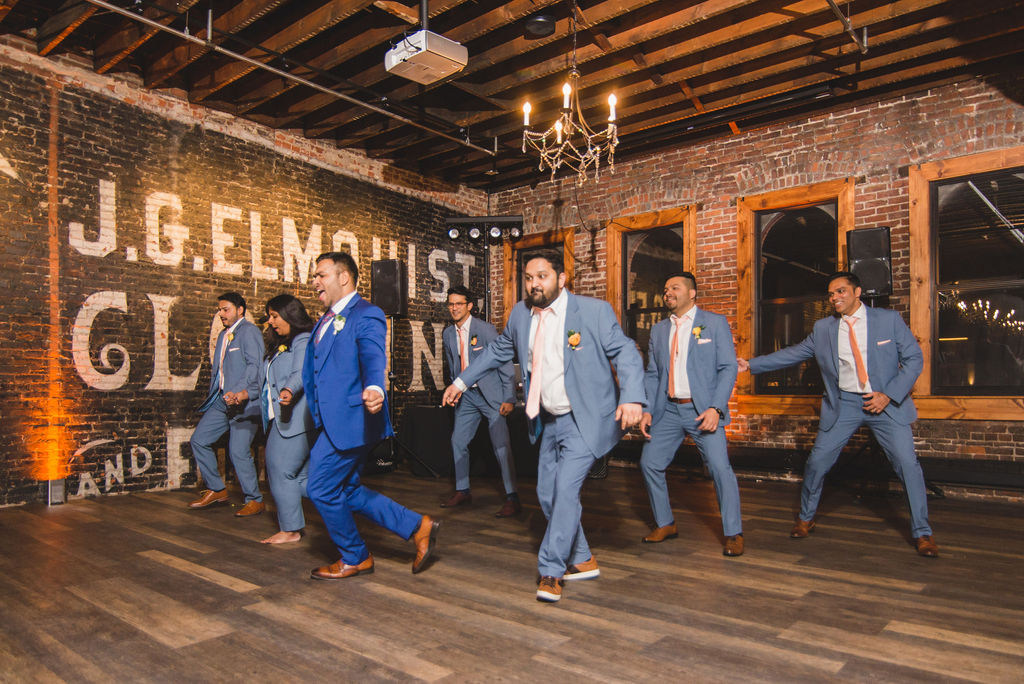 groom and groomsmen perform cultural dance