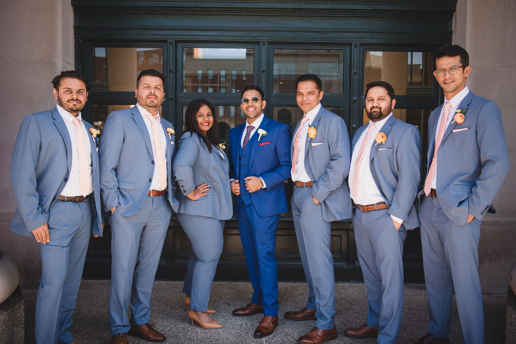 groomsmen and groomswoman with blue suits