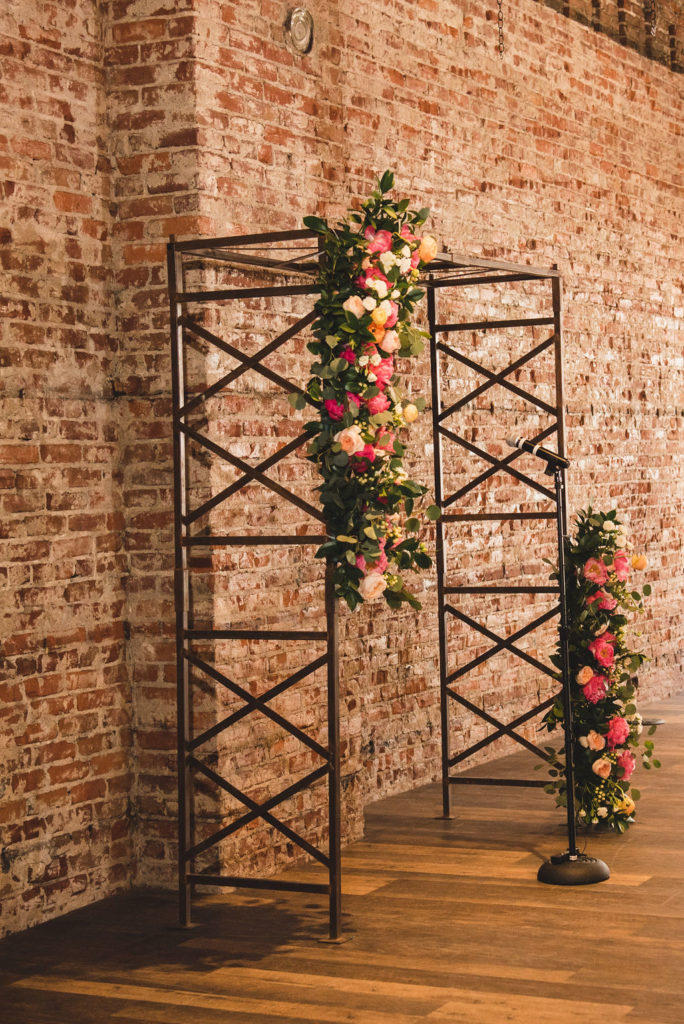 rectangular ceremony arch with colorful floral installations