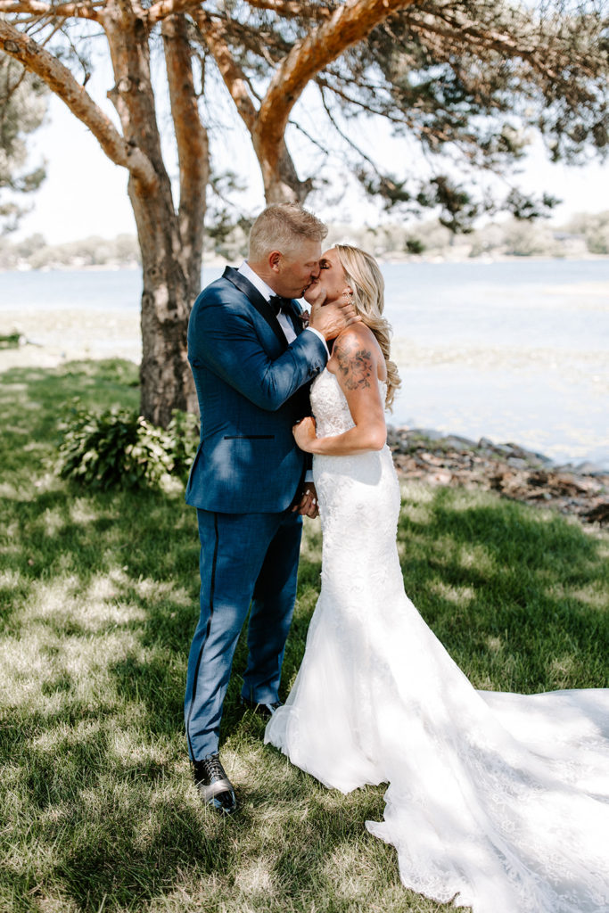 bride and groom kissing portrait lakeside