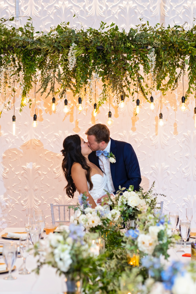 bride and groom reception kiss at head table