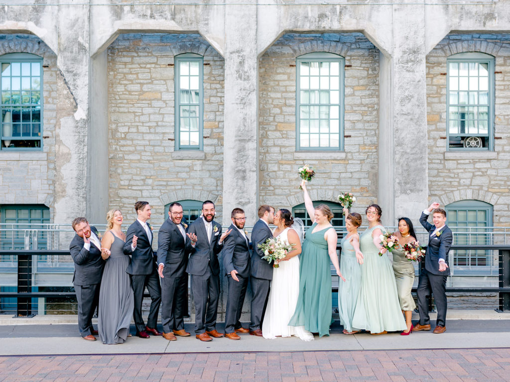 wedding party celebrating gray suits and green dresses