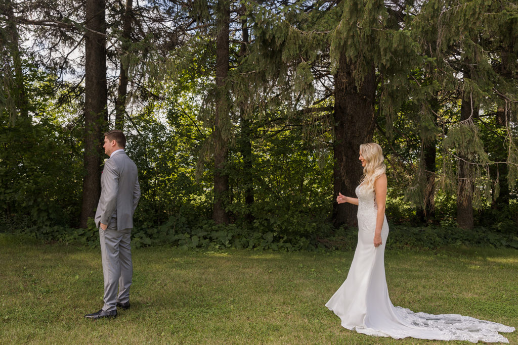 bride-groom-first-look-outside-woods