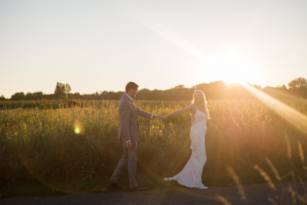 couple-sunset-portrait-holding-hands-prairie-field