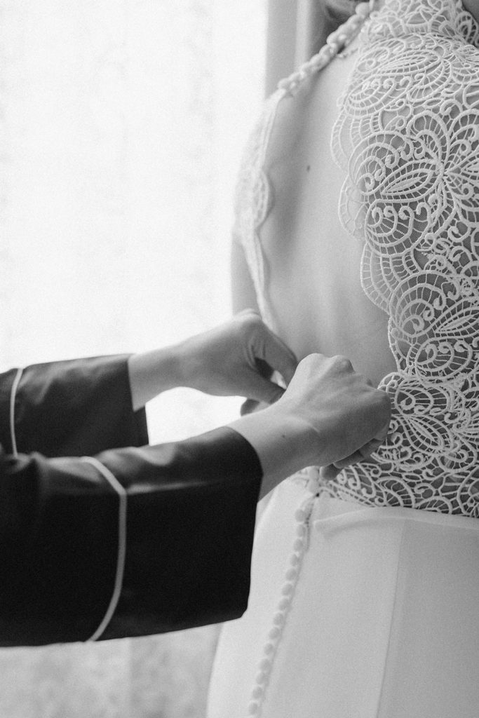 bride-getting-dressed-details-open-back-dress