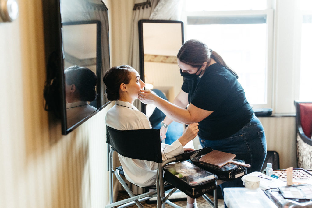 bride-getting-ready-hair-makeup-hotel-suite