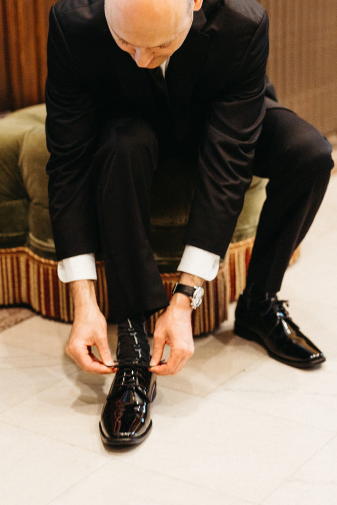 groom-getting-ready-black-dress-shoes