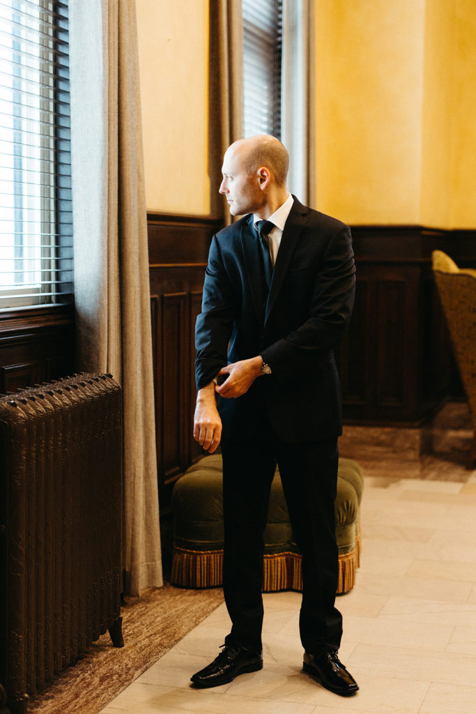 groom-getting-ready-black-suit