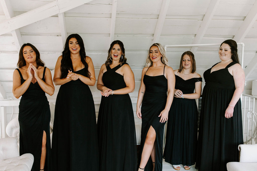 bridesmaids-reaction-first-look-bride-black-bridesmaid-dresses