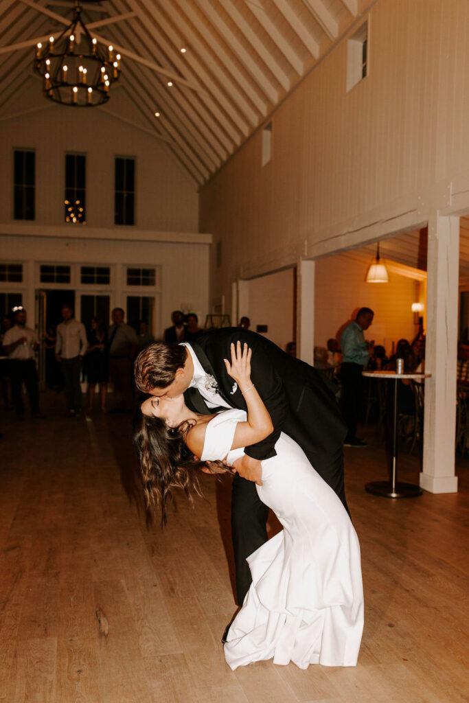 bride-groom-first-dance-dip-kiss-romantic-redeemed-farm