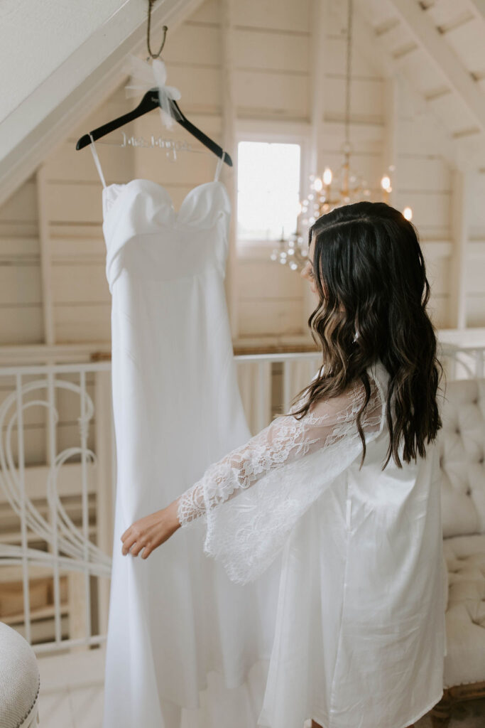 bride-with-wedding-dress-in-white-bridal-suite