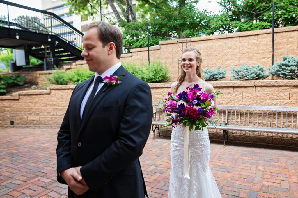 bride-groom-first-look-outside-colorful-bouquet