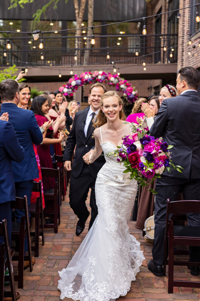 bride-groom-walking-down-aisle-celebrating-recessional-best-wedding-photos