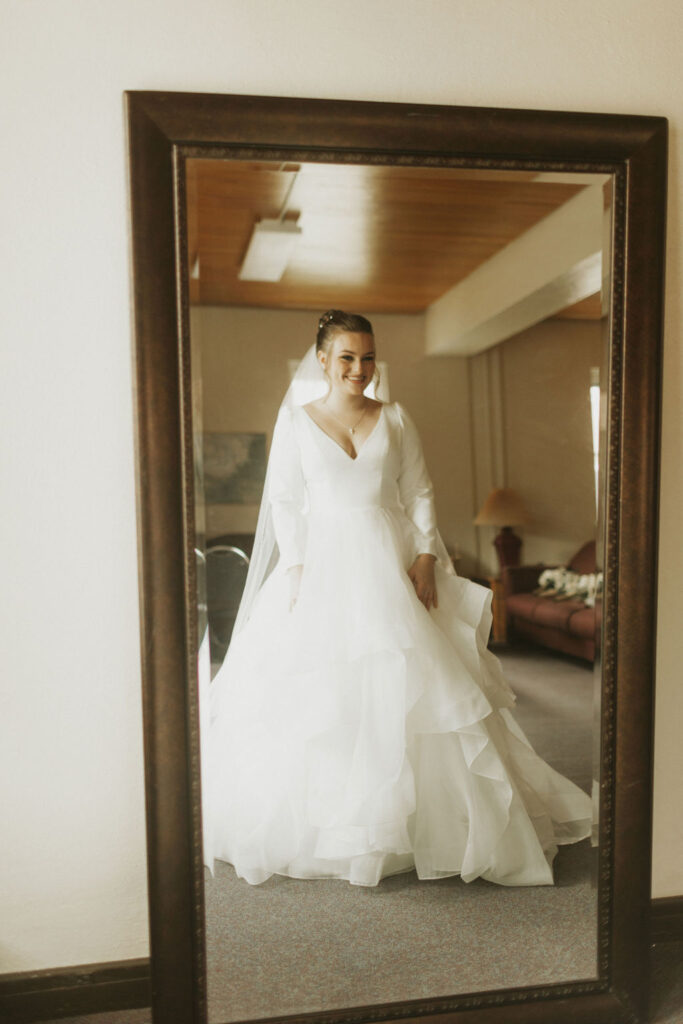 bride-ready-looking-in-mirror-ruffled-wedding-dress