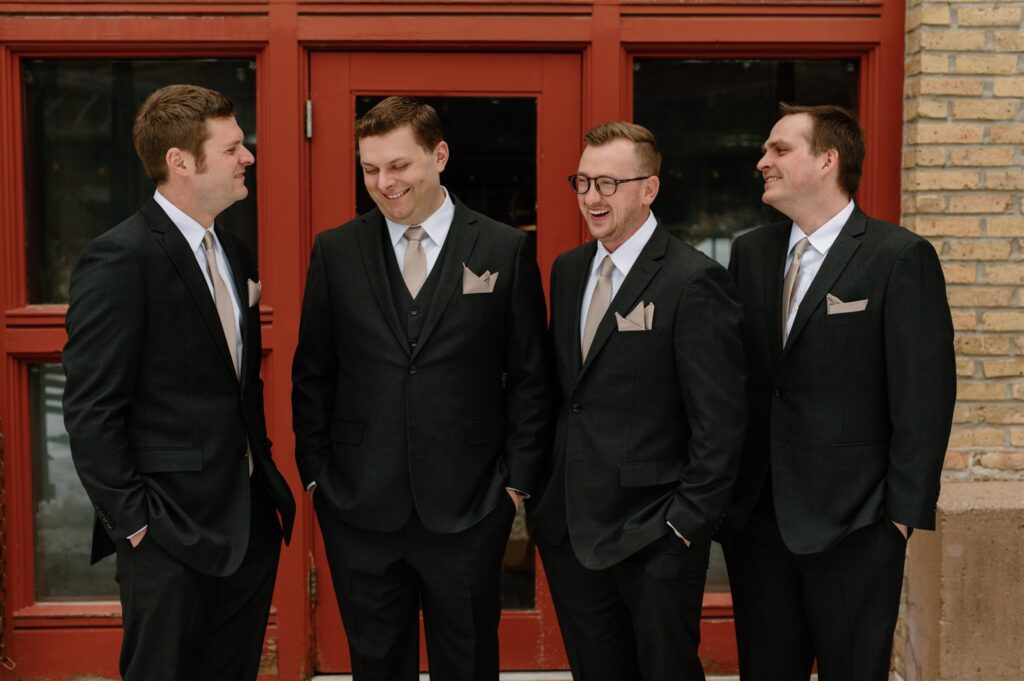 groomsmen black suits with tan pocket square