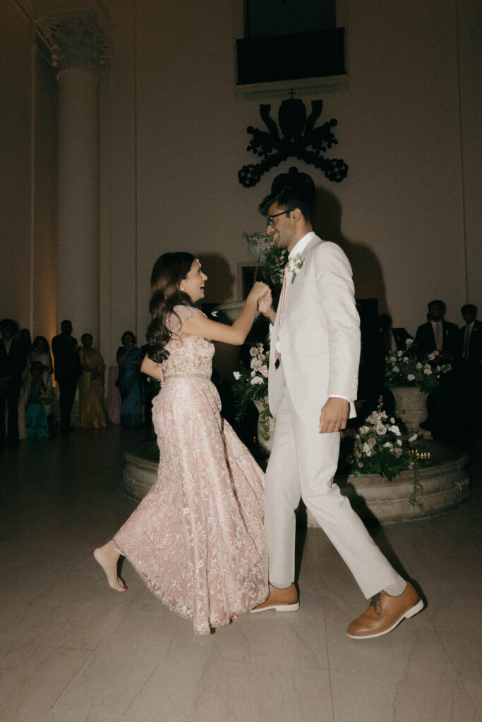 bride and groom doing cultural wedding dance in Minneapolis Institute of Art 