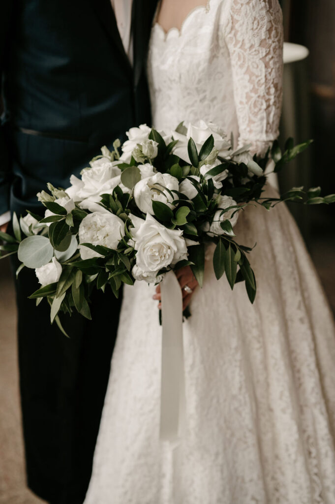 bride and groom details with bouquet