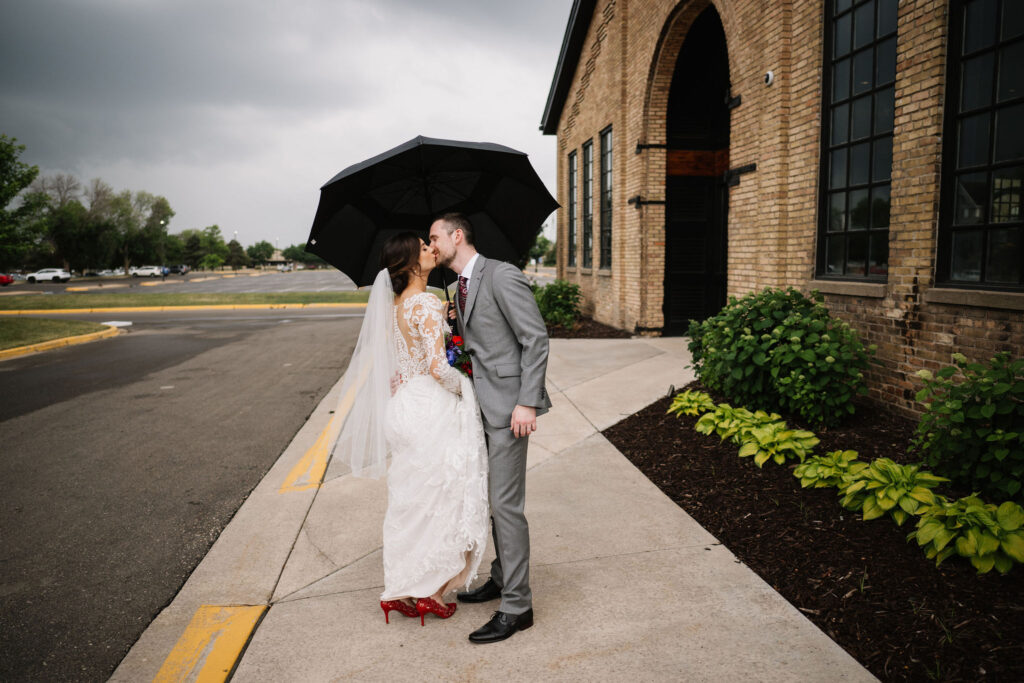 bride and groom portrait with black umbrella at Essence Event Center