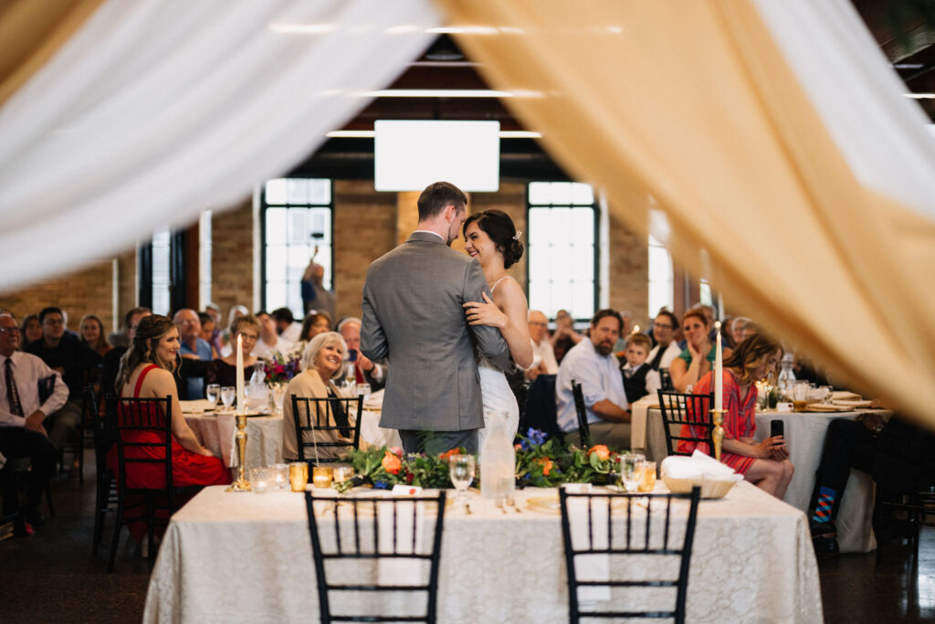 unique photo of bride and groom first dance through draping