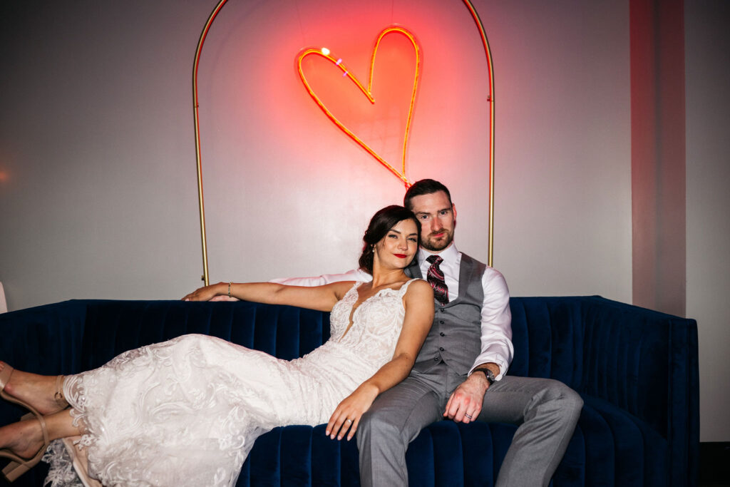 bride and groom with LED red heart sign
