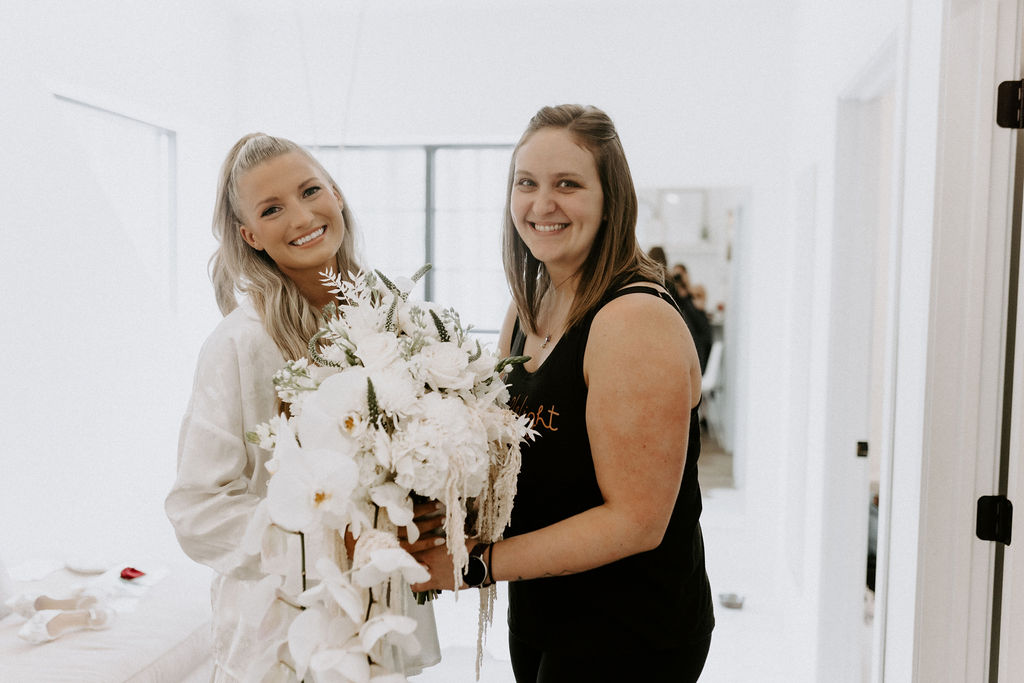 bride with florist for first look at bridal cascading bouquet