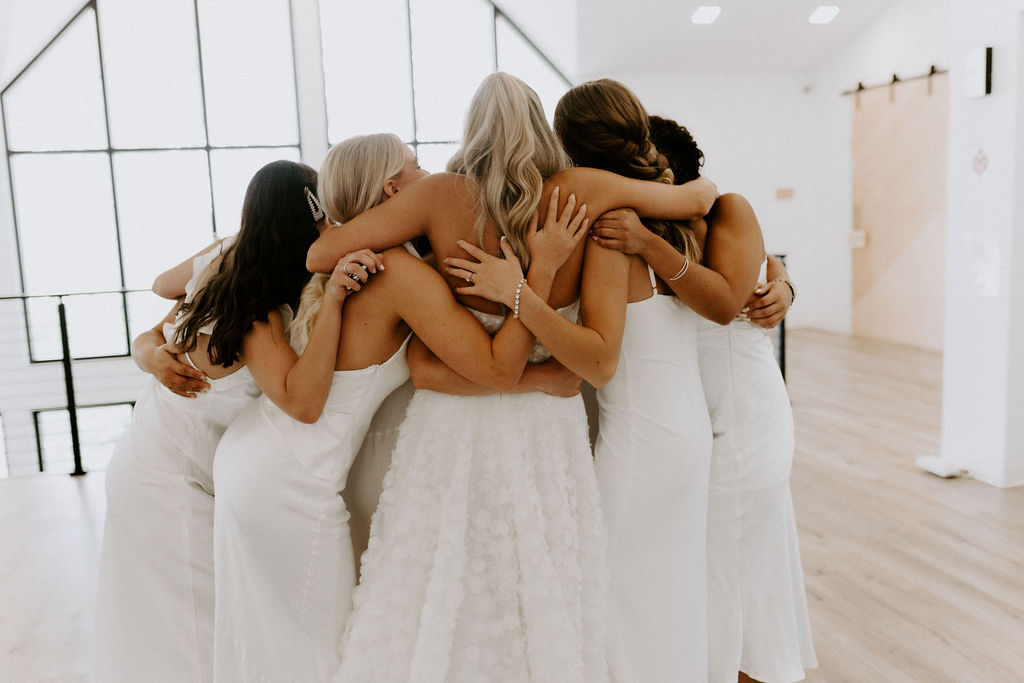 bridesmaids group hug after first look