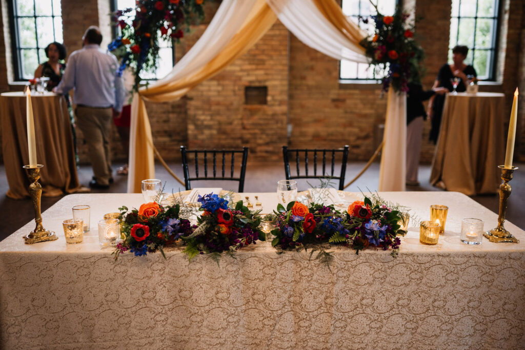 gold and colorful sweetheart table