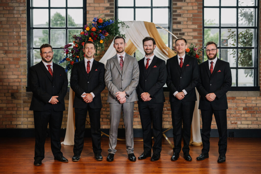 groomsmen photo with black suits and red ties