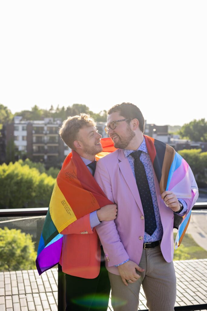 groom portrait with pride flag and colorful suits at walker art center wedding