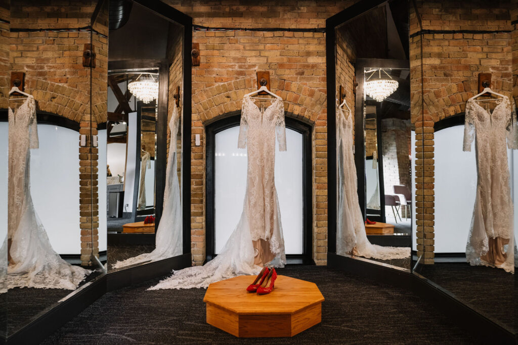 bridal details in mirror room wedding dress hanging at Essence Event Center