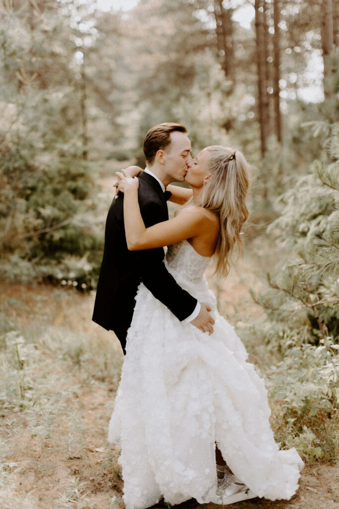 bride and groom kiss in woods at Pinewood MN 