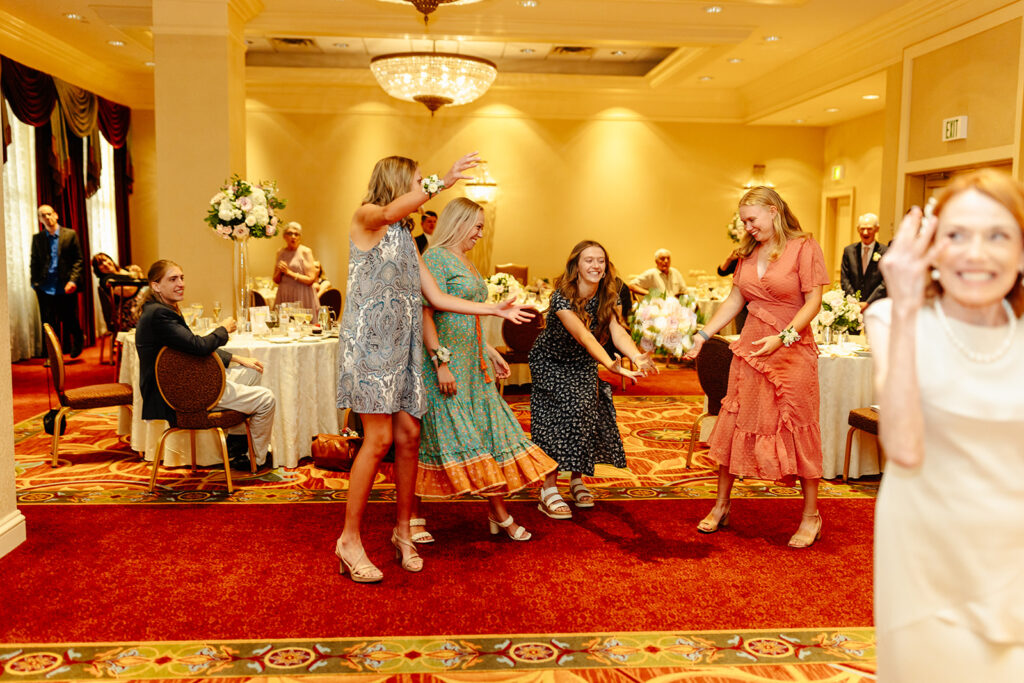 catching bouquet toss at intimate wedding reception