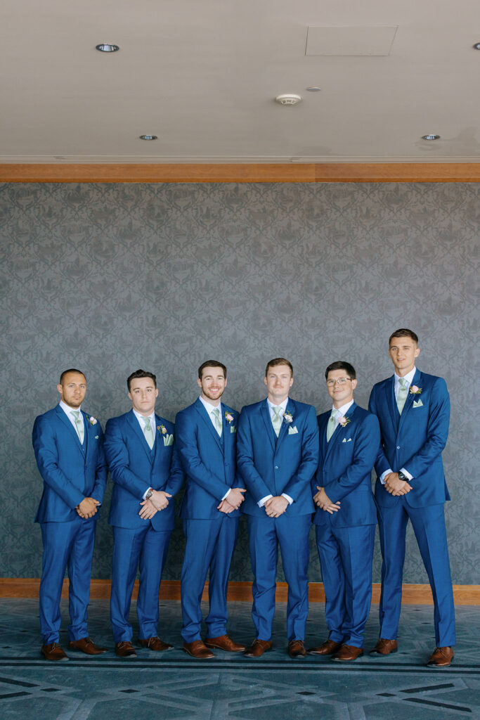 groomsmen in blue suits with mint tie