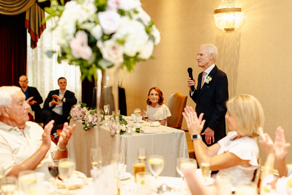 groom giving speech at intimate wedding reception