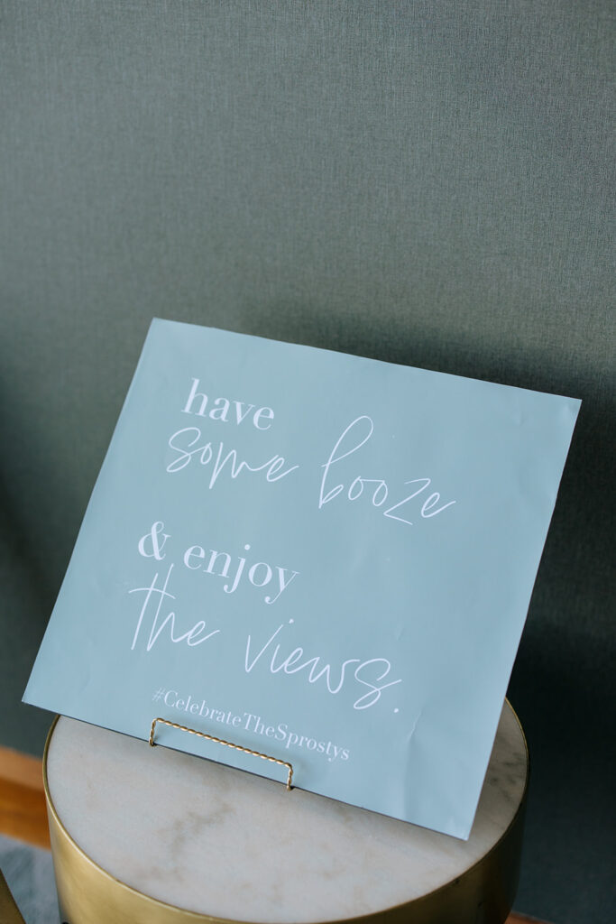 unique wedding sign saying "have some booze & enjoy the views"