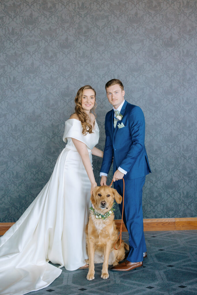 bride and groom with their dog on wedding day