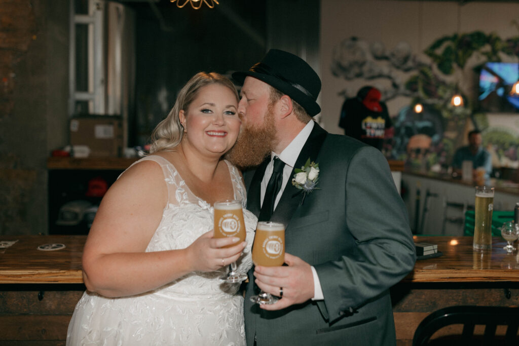 bride and groom with drinks during cocktail hour