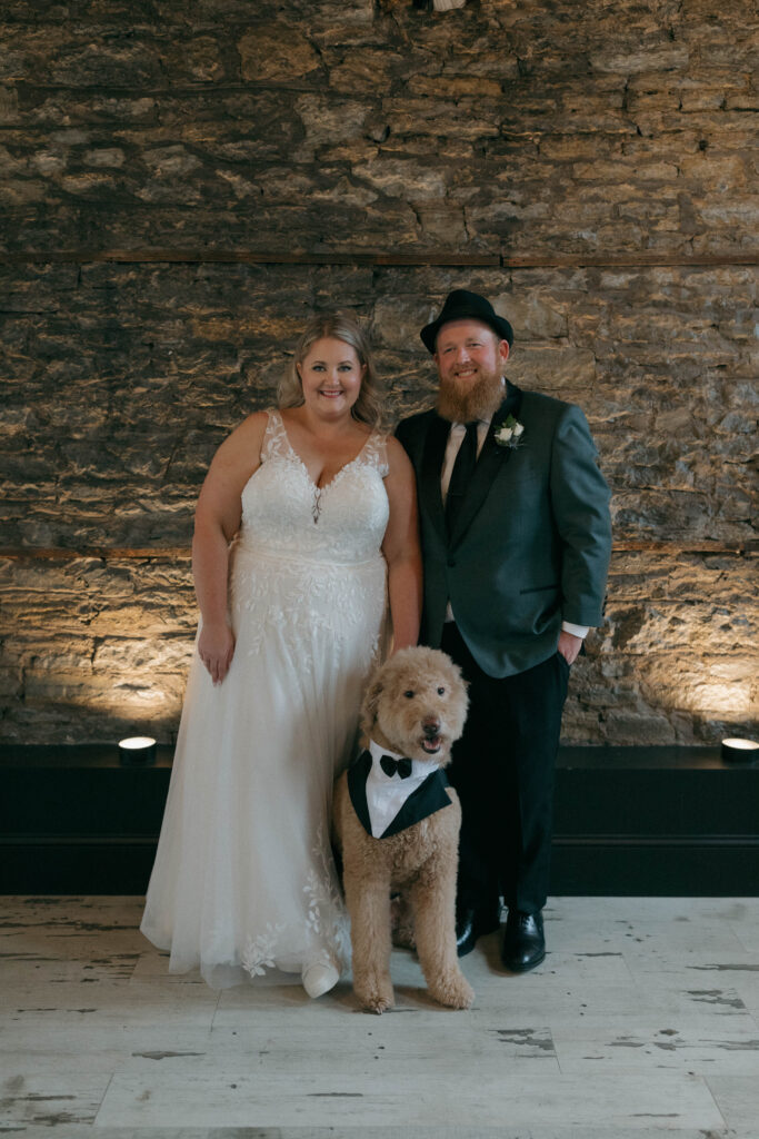 bride and groom portrait with dog in suit