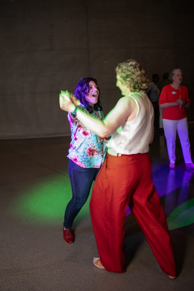 lbgt couple on dance floor with Instant Request at 10th anniversary party