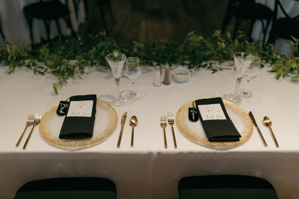 bride and groom place settings on sweetheart table