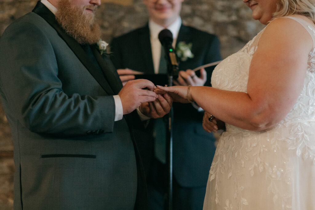 bride and groom exchanging rings at intimate wedding